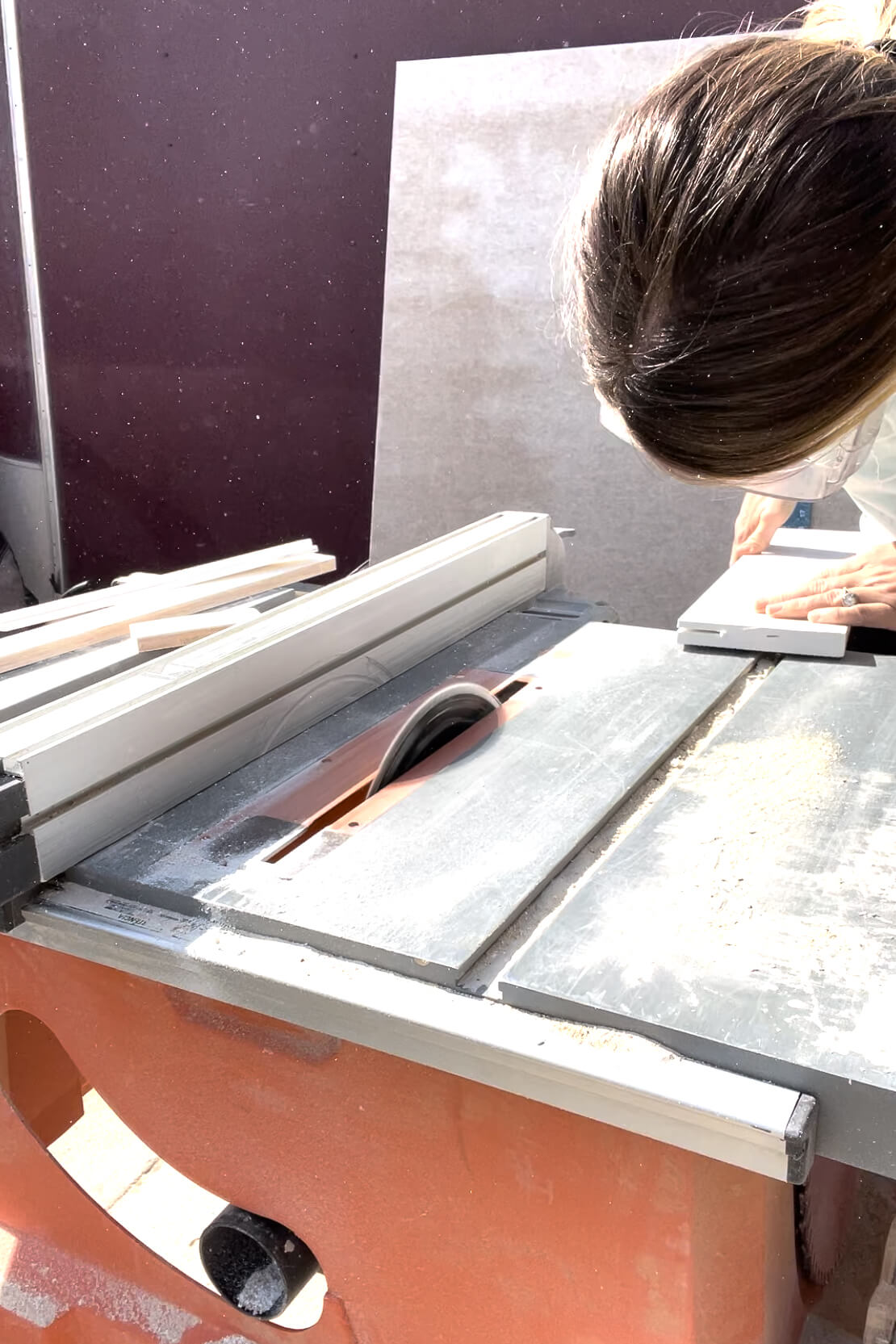 Using a table saw to cut PVC trim.